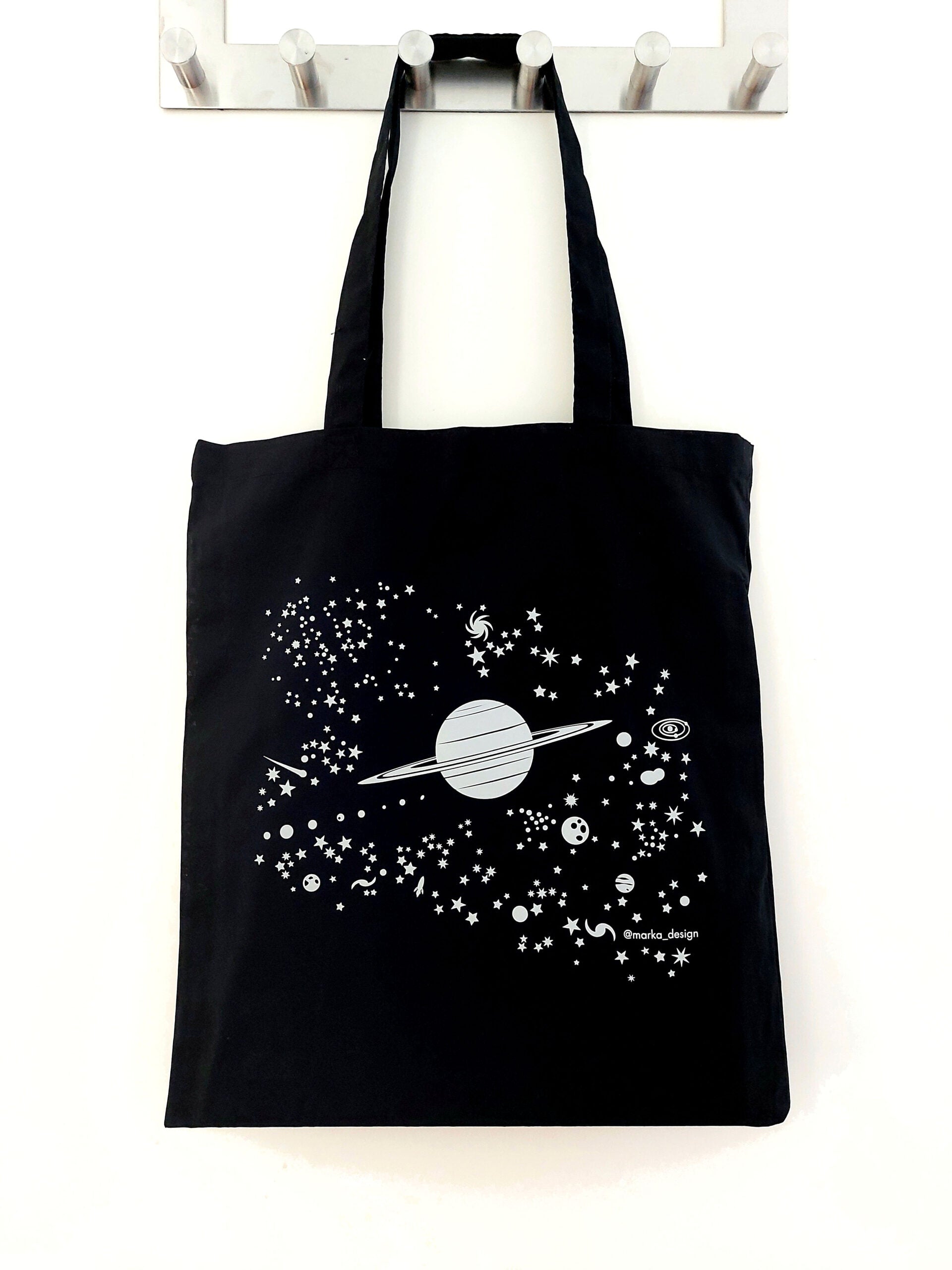 Tygväska Saturnus, reflekterande